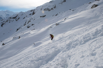 freeride skier skiing in deep powder snow