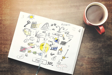 notebook, pen and tea on table