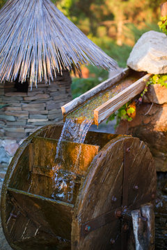 wooden wheel that turns water