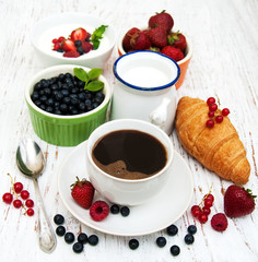 Fresh berries, coffee and croissant