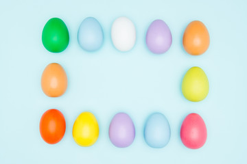 Colorful easter eggs on pastel background