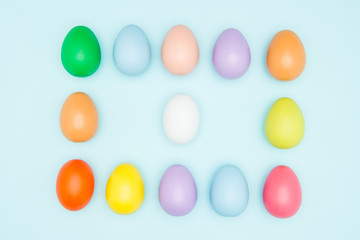 Colorful easter eggs on pastel background