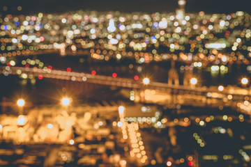 Obraz premium night city unfocused, view from the top at Osaka bay area at night with city light, bridge and attractions