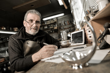 Master goldsmith working with silver-Creative drawing of a silve