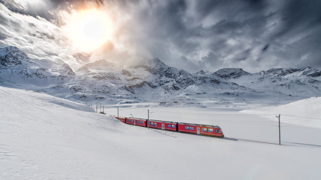 Fototapeta Swiss mountain train Bernina Express crossed through the high mo