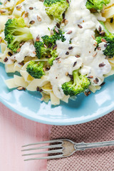 Pasta dish broccoli sauce sunflower seeds
