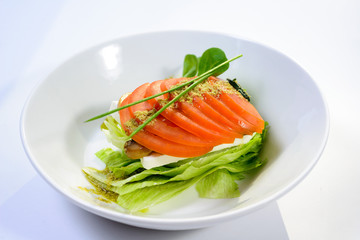 classic Caprese salad with tomatoes, cheese, herbs and sauce