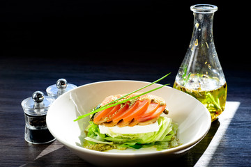 classic Caprese salad with tomatoes, cheese, herbs and sauce