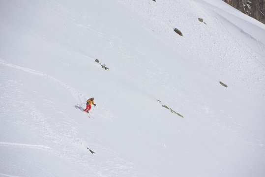 freeride skier skiing in deep powder snow