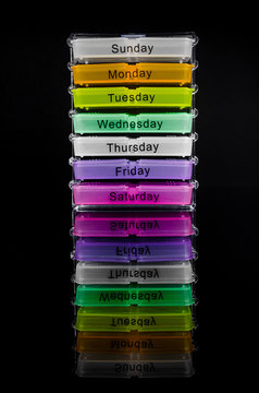 Colorful Pill Box On Black Background With Reflection