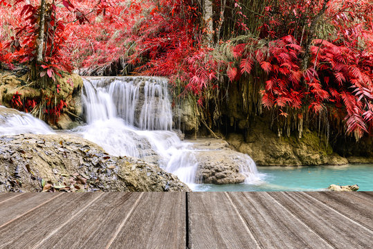 Vintage Style Wooden Floor Perspective With Beautiful Autumn Waterfall.