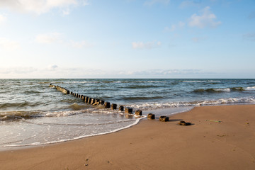 Breakwater of one row of wooden poles at the Sea coast