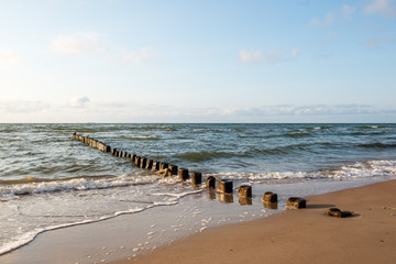 Breakwater of one row of wooden poles at the Sea coast