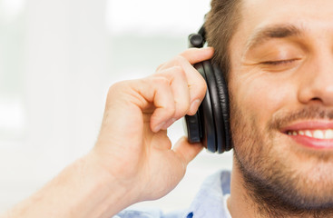 smiling young man in headphones at home