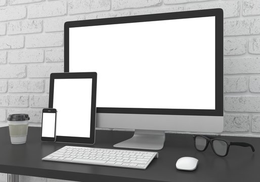 Responsive mockup screen. Monitor, tablet, phone on table in office.