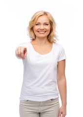 smiling woman in white t-shirt pointing to you