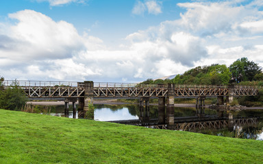 Fototapeta na wymiar Railway bridge over river Lochy in Fort William, Scotland