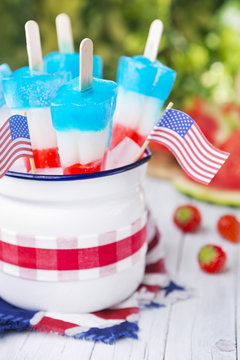Red-white-and-blue popsicles on an outdoor table