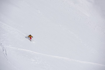 freeride skier skiing in deep powder snow