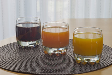 Multi fruit citrus juice from oranges, lemons, bananas, grapes in a glass