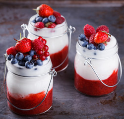 Yogurt,homemade,with fresh berries, berry puree in a glass container.Healthy eating.selective focus.