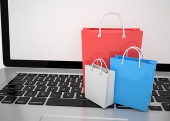 laptop and  shopping pags on white background