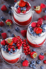 Yogurt,homemade,with fresh berries, berry puree in a glass container.Healthy eating.selective focus.