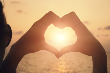 Fototapeta premium Heart shape making of woman hands