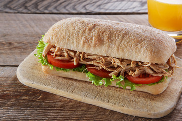 Sandwich with grilled meat tomato salad ciabatta