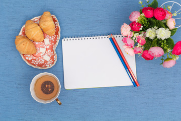 notebook, green tea and croissants