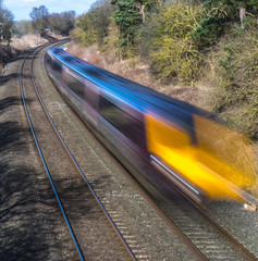 Obraz premium Train speeding through English countryside with motion blur