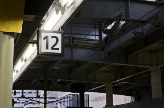Twelve number label on the train station platform.