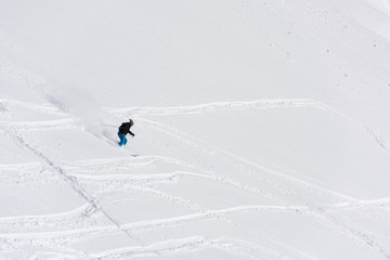 freeride skier skiing in deep powder snow