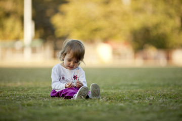 little girl playing in a field