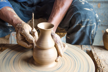 Fototapeta na wymiar Hands of making clay pot on the pottery wheel ,select focus, close-up.
