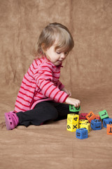 little girl stacking blocks