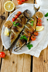 Mackerel baked with lemon, garlic and tomatoes