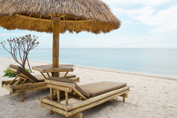 Sunbed and umbrella on a tropical beach