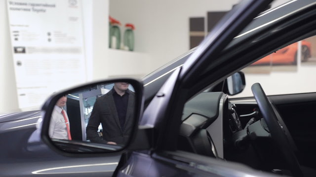 Image of car dealer with client preparing to test drive