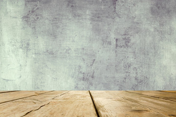 Empty wooden table over grunge grey background