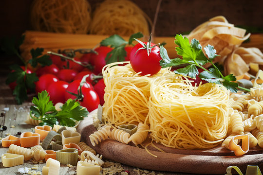 Dry Italian pasta Barbine in nests with cherry tomatoes and pars