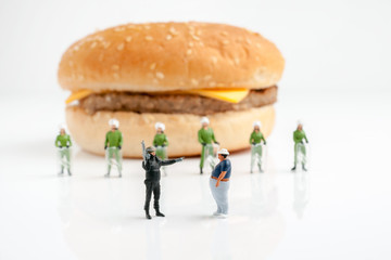 Step Away from the Burger! A police officer stops a fat man from reaching a burger a public health obesity concept