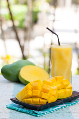 Fresh tropical fruit smoothie mango juice and fresh mango Copy space