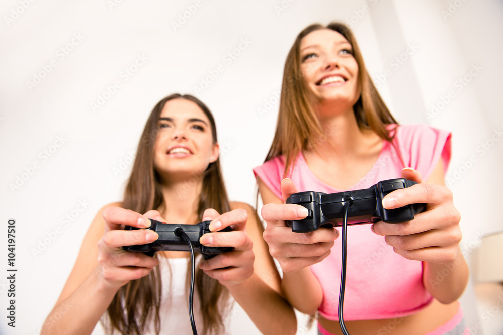 Poster close up photo of smiling cute friends playing video games