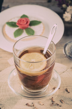 Cup of tea with lemon in the afternoon in a rustic style.