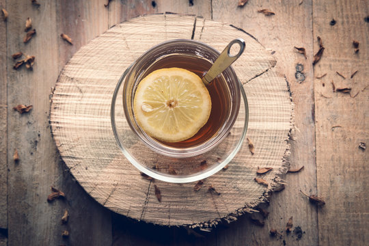 Cup of tea with lemon in the afternoon in a rustic style.