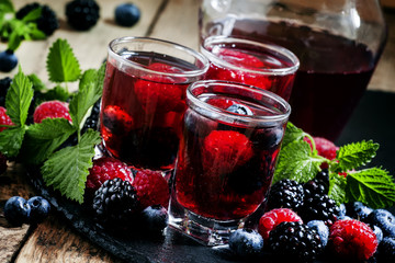 Cold summer berry tea with raspberries, blueberries, blackberrie