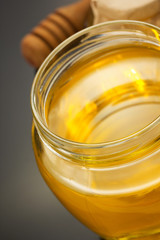 glass jar of honey on black