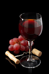 wine glass and grapes on black