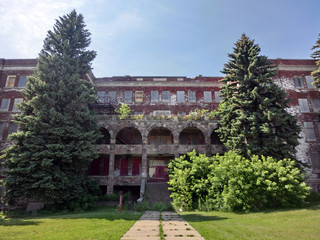 Fototapeta na wymiar Large abandoned school exterior - landscape color photo